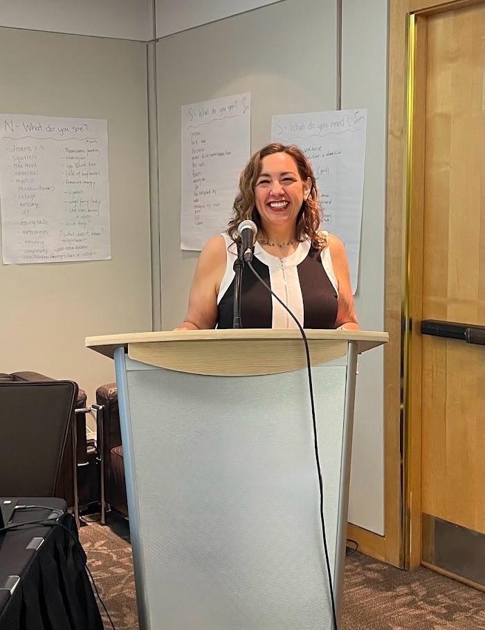 Ellice speaking at a podium